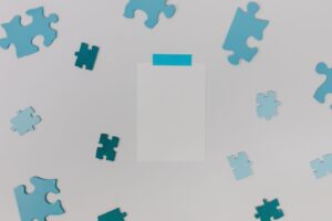 White Paper Surrounded with Puzzle Pieces