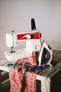 White Sewing Machine, Clothes Iron, and Scissors