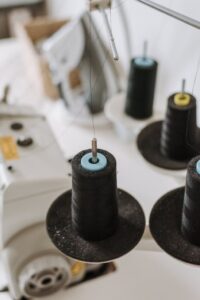 Thread spools on overlock machine in workshop