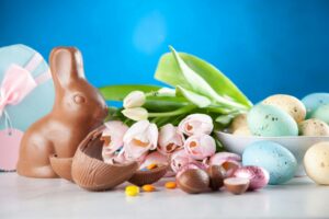 White Flowers Between Brown Rabbit Figure and Eggs