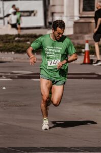 A Man in Green Shirt Running