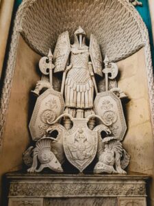 Sculpture of an Armor Suit, Shield and Axes on Display