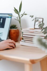 Crop remote employee working on laptop at home desk